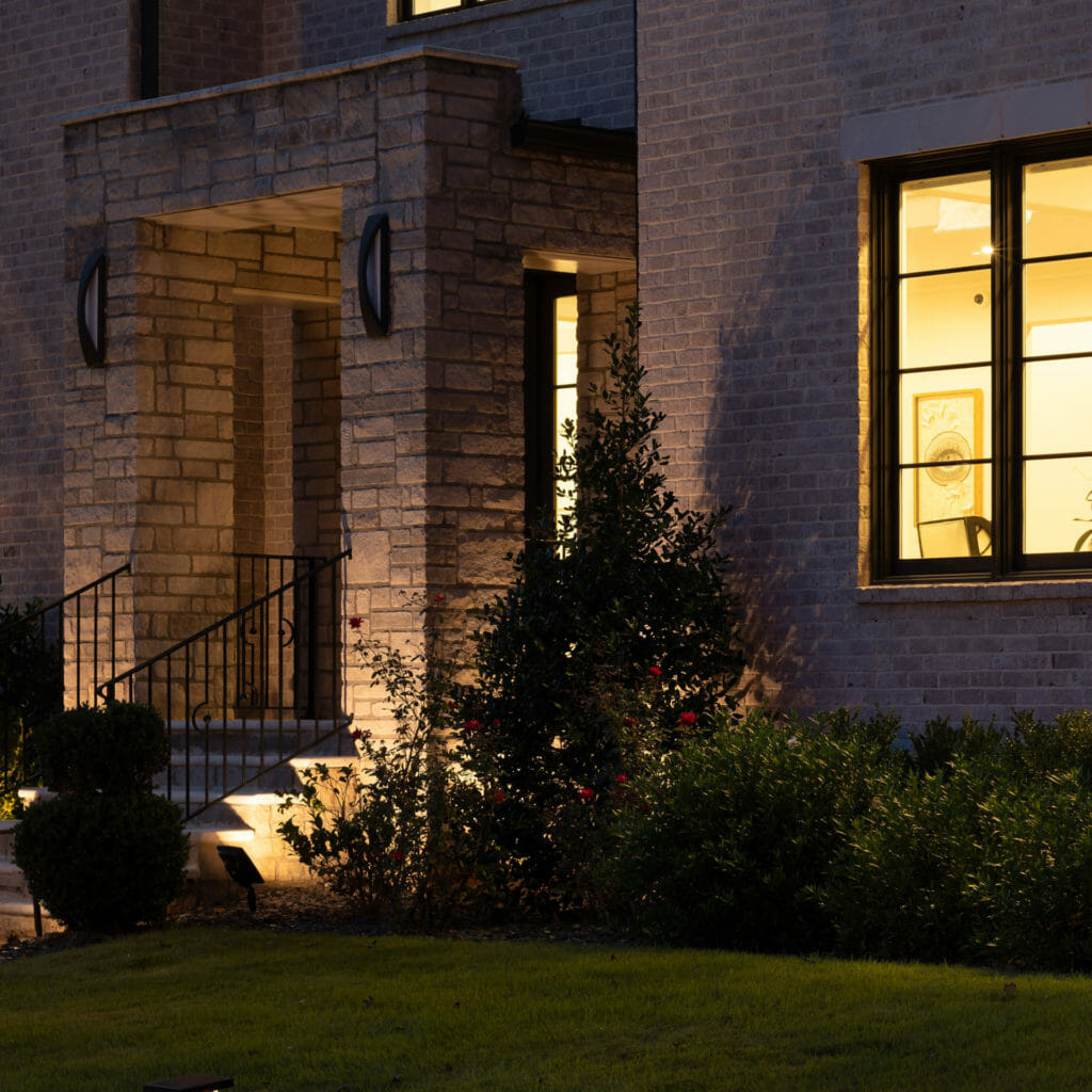 Dual Color Cast Aluminum Solar Flood Light with 5-year warranty - dusk application image modern house