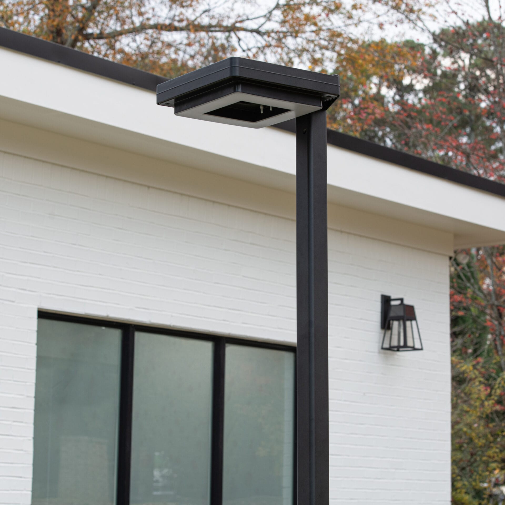 Gama Sonic contemporary solar lamp post illuminating modern walkway