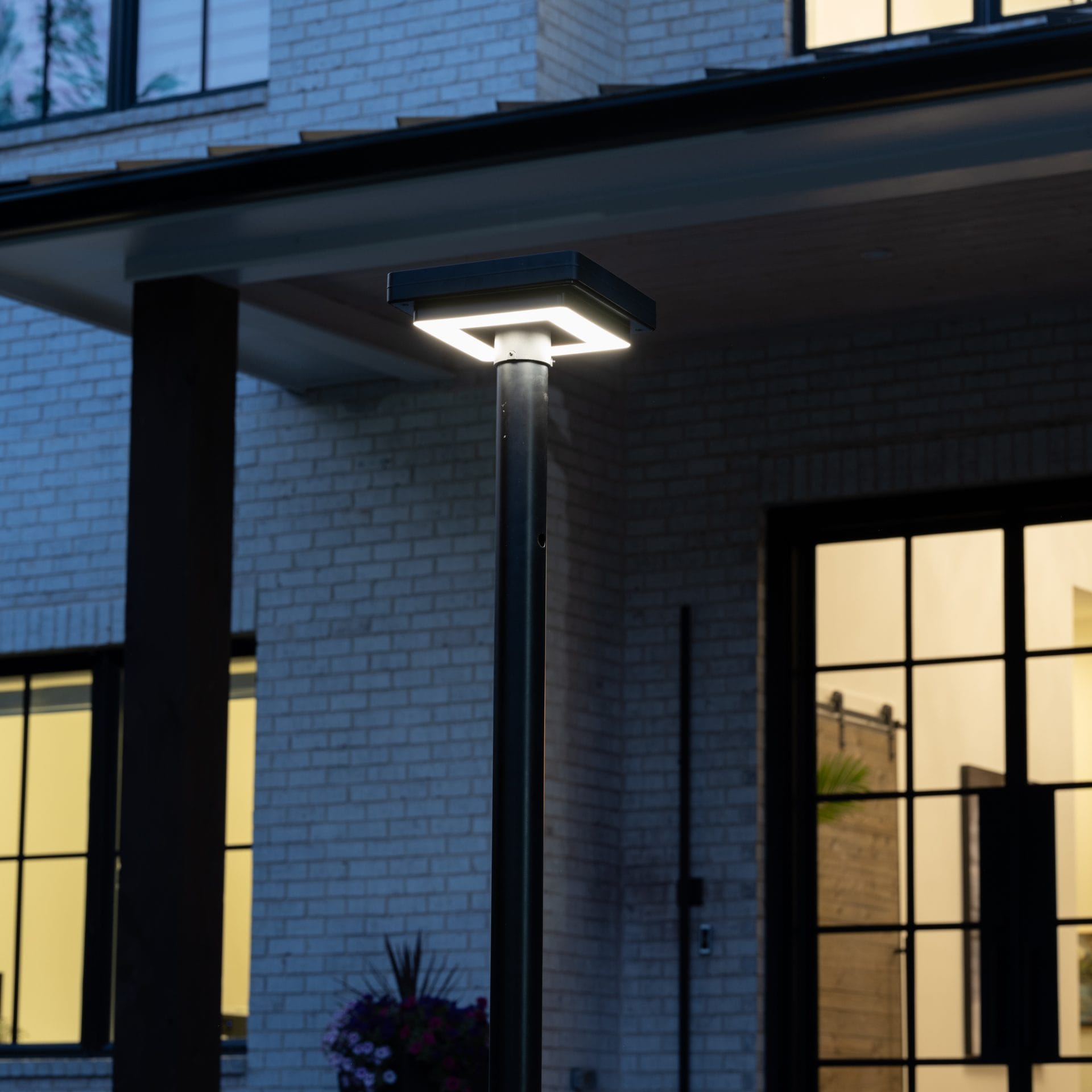 Gama Sonic contemporary solar lamp post illuminating modern walkway
