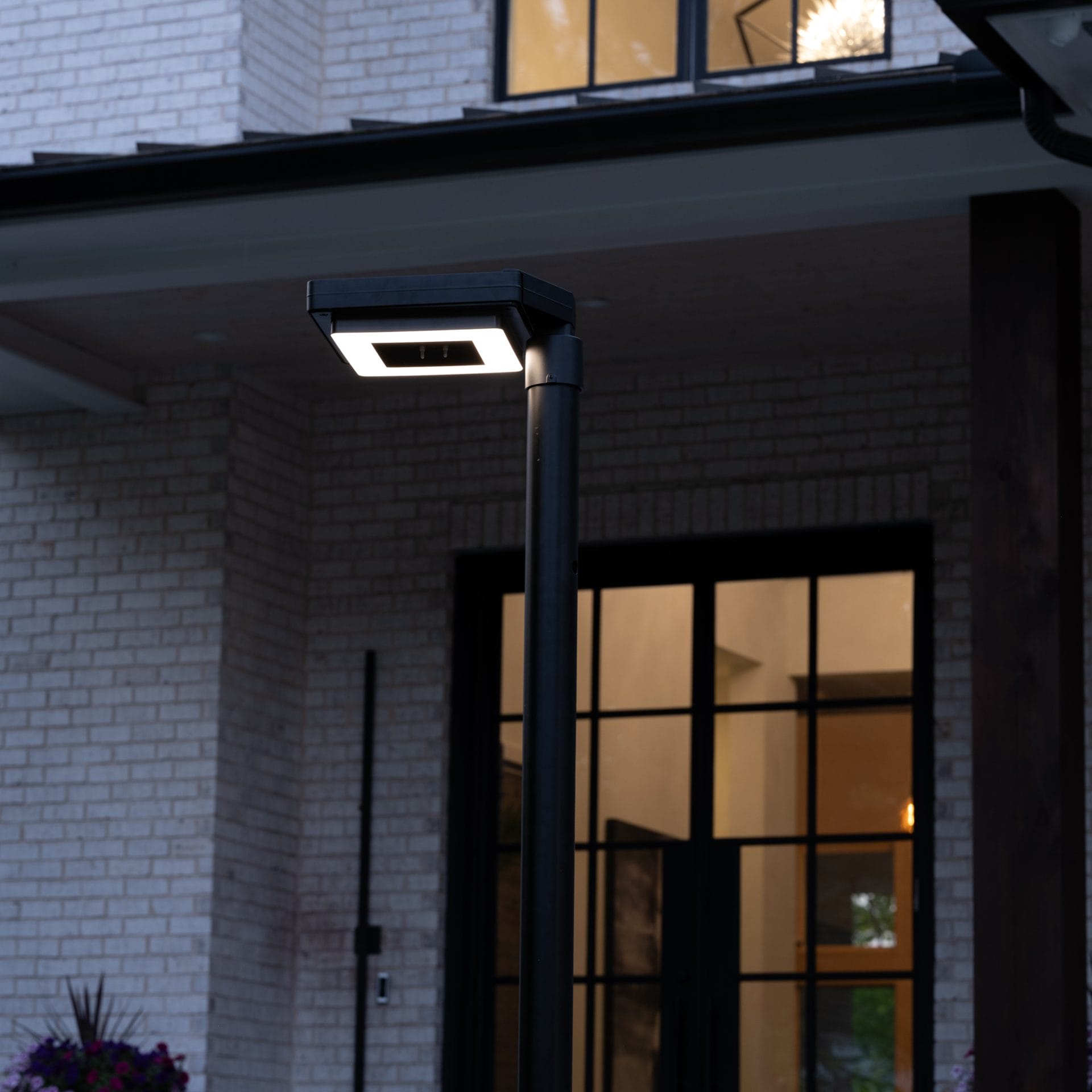 Gama Sonic contemporary solar lamp post illuminating modern walkway