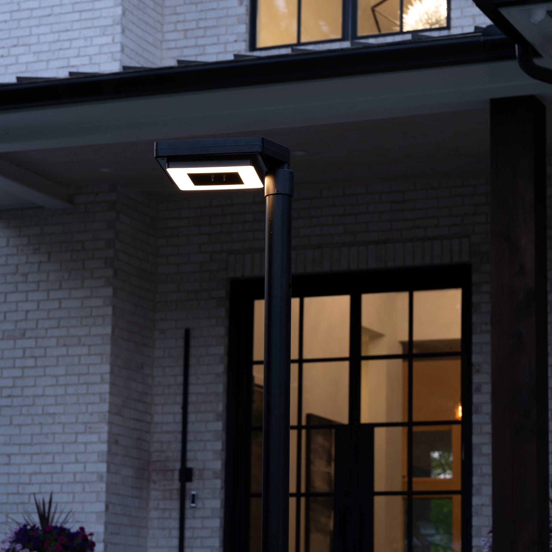 Gama Sonic contemporary solar lamp post illuminating modern walkway