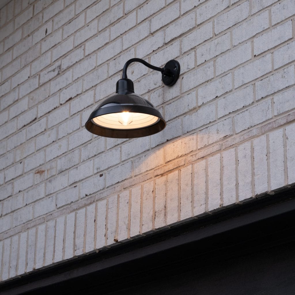Wall-mounted solar barn light with integrated solar panel for outdoor spaces - dusk application image 1